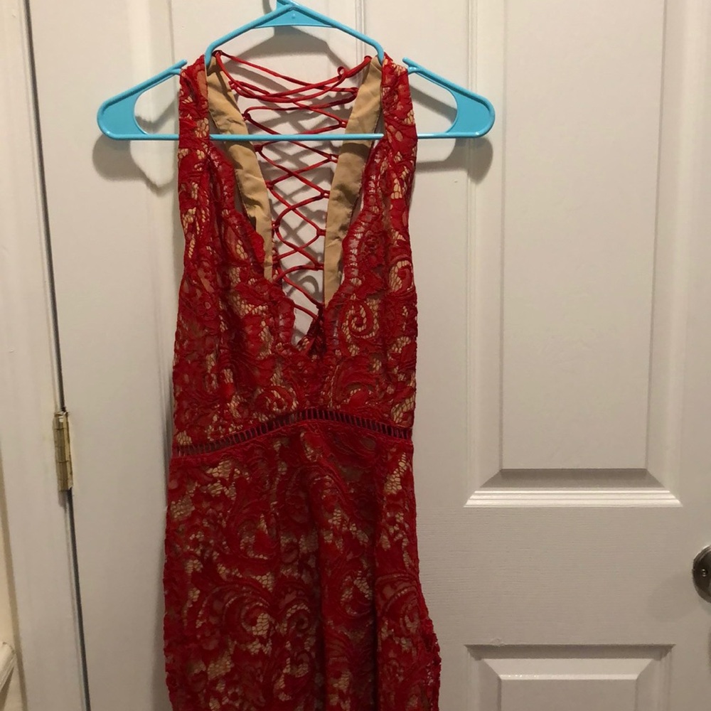 Red low v neck tight open back dress. Never worn.